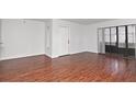 Bright living room with hardwood floors and sliding glass doors at 954 Courtyard Ln # 11, Orlando, FL 32825