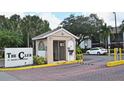 Gated community entrance with guard house and signage at 954 Courtyard Ln # 11, Orlando, FL 32825