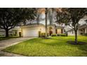 One-story house with attached garage and landscaped yard at 441 Montara Dr, Davenport, FL 33897
