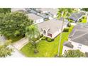 Single-Gathering home with a green lawn and palm trees at 441 Montara Dr, Davenport, FL 33897