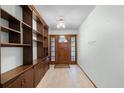 Bright entryway with built-in shelves and wood floors at 1005 Crescent Pkwy, Deland, FL 32724