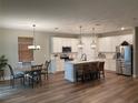 Bright kitchen featuring an island, stainless steel appliances, and breakfast bar at 726 Calabria Way, Howey In The Hills, FL 34737