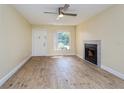 Bright living room with fireplace and wood-look flooring at 4806 S Semoran Blvd # 201, Orlando, FL 32822