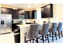 Modern kitchen with stainless steel appliances and an island with seating at 791 Pebble Beach Dr, Davenport, FL 33896