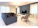 Spacious living room with a large TV and comfortable seating at 791 Pebble Beach Dr, Davenport, FL 33896