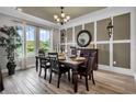 Bright dining room featuring a large table, hardwood floors, and windows with a scenic view at 10093 Atwater Bay Dr, Winter Garden, FL 34787