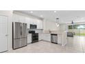 Modern kitchen with white cabinets and stainless steel appliances at 3824 Grassland Dr, Orlando, FL 32824