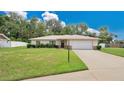 Single-story home with a one-car garage and landscaped lawn at 3472 Country Walk Dr, Port Orange, FL 32129