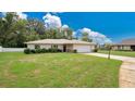 Single-story home with a one-car garage and landscaped lawn at 3472 Country Walk Dr, Port Orange, FL 32129