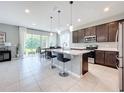 Modern kitchen with stainless steel appliances and an island at 8060 Cherrystone St, Leesburg, FL 34748
