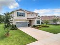 Two story home with teal shutters and gray garage at 8060 Cherrystone St, Leesburg, FL 34748