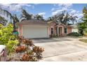 Pink house with white garage door and a spacious driveway at 715 Unabelle Ave, Daytona Beach, FL 32117