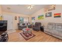 Living room with hardwood floors, comfy sofas, and a large TV at 715 Unabelle Ave, Daytona Beach, FL 32117