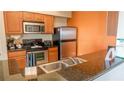 Modern kitchen with stainless steel appliances and granite countertops at 8125 Resort Village Dr # 3514, Orlando, FL 32821