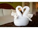 Bedroom with neatly made beds and decorative towels at 8125 Resort Village Dr # 3514, Orlando, FL 32821