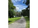 Scenic paved pathway leading to a tranquil lake at 836 Rosemere Cir, Orlando, FL 32835