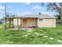 Large backyard with covered patio and grassy area at 5351 E Johnson Ave, Haines City, FL 33844