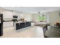 Open-concept kitchen and living area with island at 1820 Holden Ridge Ln, Clermont, FL 34715