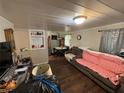 Living room with dark hardwood floors and a coral couch at 1117 E Hubbard Ave, Deland, FL 32724