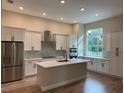 Modern kitchen with white cabinets, quartz countertops, and stainless steel appliances at 1420 Lake Harney Rd, Geneva, FL 32732