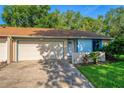 Cute light blue house with attached garage and well-maintained lawn at 108 Clear Lake Cir, Sanford, FL 32773