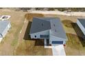 Aerial view of a new construction home with gray exterior and blue garage at 7883 Sw 138Th Street Rd, Ocala, FL 34473