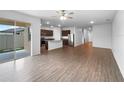 Open living room and kitchen with laminate floors at 6122 Dolostone Dr, Lakeland, FL 33811
