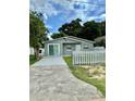 Newly renovated home with a gray exterior and a white picket fence at 117 N Observatory Dr, Orlando, FL 32835