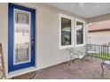 Inviting front porch with blue door and seating at 1890 Altavista Cir, Lakeland, FL 33810