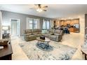 Open concept living room with a view into the kitchen at 1471 Rolling Fairway Dr, Davenport, FL 33896