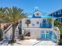 Quaint coastal cottage featuring a blue roof and white exterior at 2903 Hill St, New Smyrna Beach, FL 32169