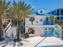 Charming beach cottage with blue accents and a landscaped front yard at 2903 Hill St, New Smyrna Beach, FL 32169