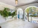 Relaxing covered patio with arched entryways and lush tropical plants at 2903 Hill St, New Smyrna Beach, FL 32169