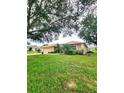 Single-story home with a two-car garage and spacious lawn at 9854 Crenshaw Cir, Clermont, FL 34711