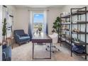 Home office with desk, chair, shelving, and natural light at 7163 Painted Bunting Way, St Cloud, FL 34773