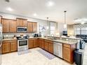 Modern kitchen with stainless steel appliances and granite countertops at 1410 Wexford Way, Davenport, FL 33896