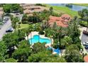 Resort-style pool surrounded by lush landscaping at 7310 Westpointe Blvd # 623, Orlando, FL 32835