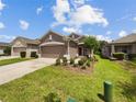 Single-story house with a two-car garage and landscaped front yard at 3420 Sagebrush St, Harmony, FL 34773