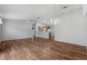 Spacious living room with wood floors and a view into the kitchen at 17479 Se 82Nd Pecan Ter, The Villages, FL 32162