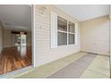 Covered porch with view into living area, wood-look flooring at 17394 Se 74Th Seabrook Ct, The Villages, FL 32162