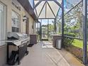 Outdoor kitchen with grill and screened enclosure at 143 Brunswick Dr, Davenport, FL 33837