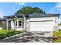 Newly built home with gray siding, white garage door and stone accents at 2866 Lingo Ln, Orlando, FL 32822