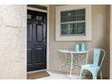 Charming front door entry with a small table and chair at 1473 Farrindon Cir, Lake Mary, FL 32746