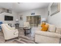 Living room with beige sofa, chairs, and wood-look floors at 141 Napoli Dr, Davenport, FL 33897