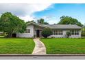 Mid-century modern home with walkway leading to front entrance at 400 W Trotters Dr, Maitland, FL 32751