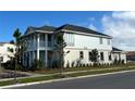 Side view of a modern two-story home with a balcony and neat landscaping at 9982 Fiddley Aly, Orlando, FL 32827