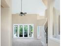 Large living room with double doors leading to the outside at 6659 Crenshaw Dr, Orlando, FL 32835