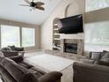 Living room with fireplace and large TV at 6659 Crenshaw Dr, Orlando, FL 32835