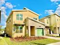 Two-story house with light beige walls, stone accents, and a green garage door at 9095 Sommerset Hills Dr, Davenport, FL 33896