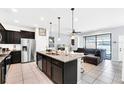 Open kitchen with granite countertops and stainless steel appliances at 8930 Sydney Ave, Kissimmee, FL 34747